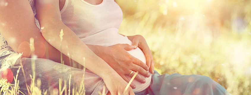 Pregnant couple in the sun